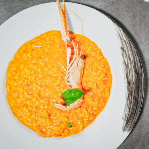Risotto carnaroli mantecato alle codi di scampi alla certosina - Da Dino il migliore ristorante di pesce a Torino